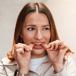 Patient putting on clear aligner