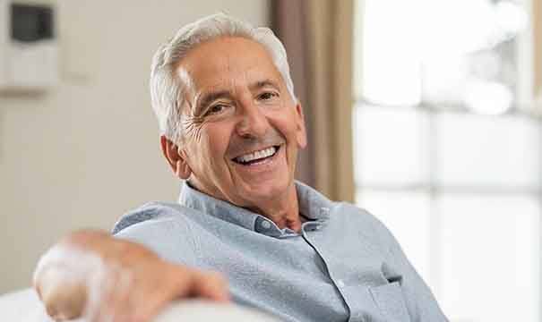 man smiling after getting dental implants