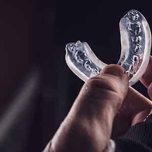 person holding mouthguard