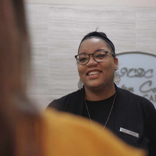 Newton dental team member talking to a patient at front desk